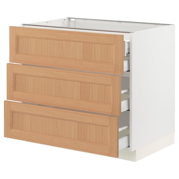 A modern SEKTION kitchen cabinet with three natural oak drawers and soft-close drawers.