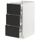 Modern white kitchen cabinet with three black drawers, sleek design.