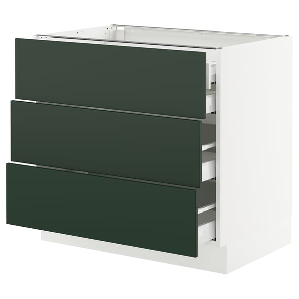 A SEKTION kitchen cabinet with three dark green drawers and a white base.