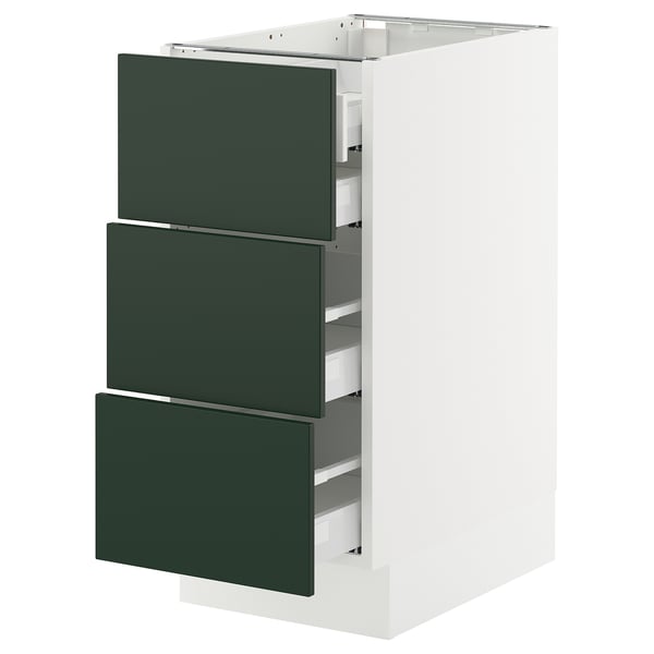 White SEKTION kitchen cabinet with green drawers.