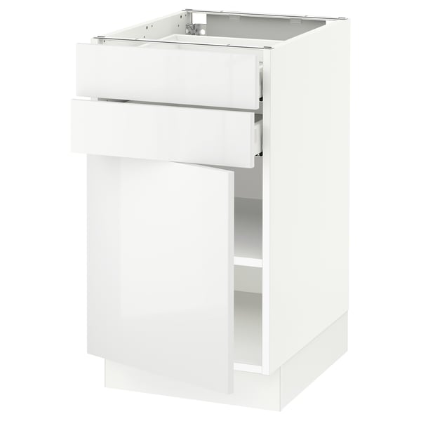 A white SEKTION kitchen cabinet with a drawer and open shelf. It high gloss doors and a sleek, modern design.