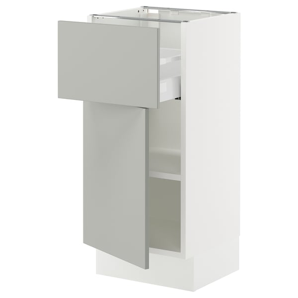 SEKTION kitchen cabinet in light grey with adjustable shelves and soft-close drawer.