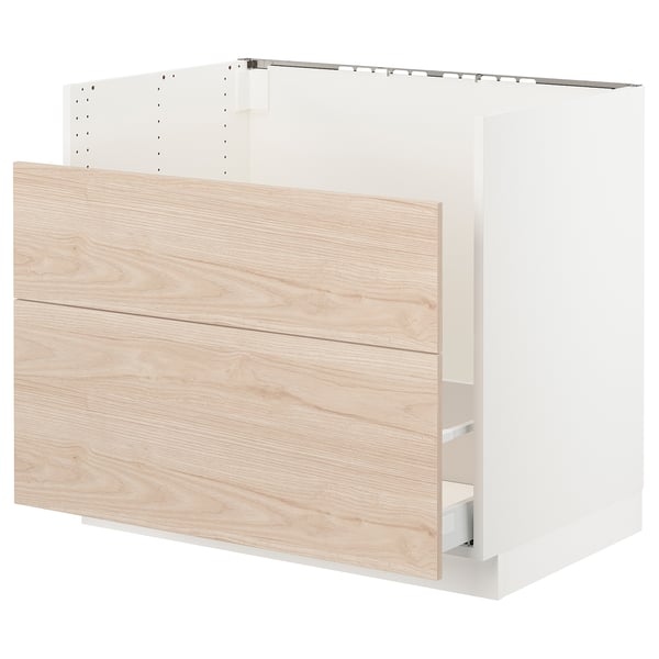 A white and light wood SEKTION kitchen cabinet with drawers and shelves, designed with a modern style.