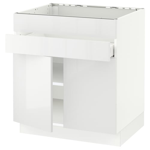 A white SEKTION kitchen cabinet with glossy doors and a modern design.