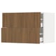 Depicts a modern kitchen cabinet system named SEKTION with wooden walnut fronts, featuring smooth surfaces and a sleek design.