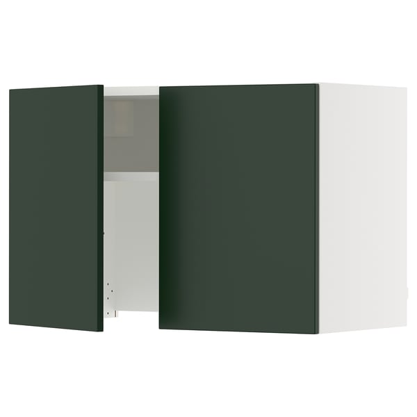 A green SEKTION kitchen cabinet with one door open, revealing shelves inside. The cabinet is rectangular with a sleek design.