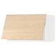Woodgrain kitchen cabinet with slanted top, light wood finish.