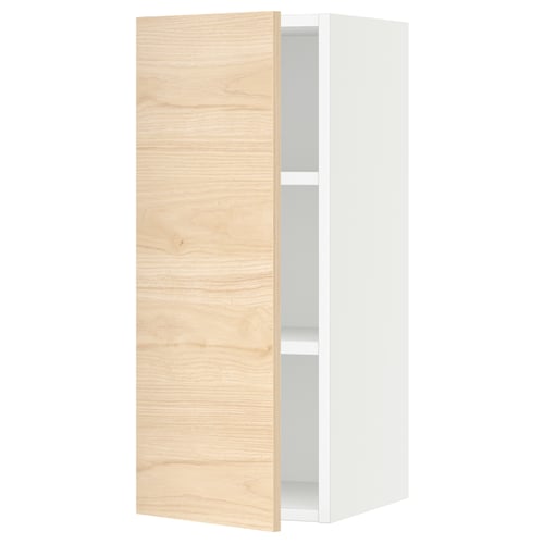 An open white cabinet with a light wooden door and a visible shelf inside.