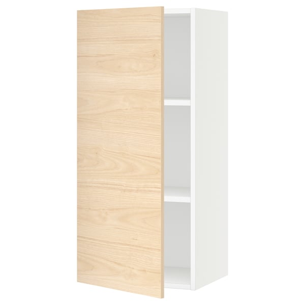 A white SEKTION kitchen wall cabinet with a light ash wood door, featuring adjustable shelves.