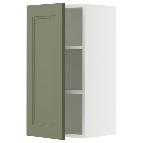 A grey-green ikea SEKTION kitchen cabinet with a square door, featuring adjustable shelves and a soft-close hinge.