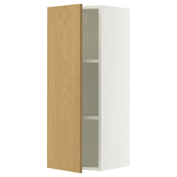 A white SEKTION wall cabinet with a light oak veneer door open, revealing an adjustable shelf inside.