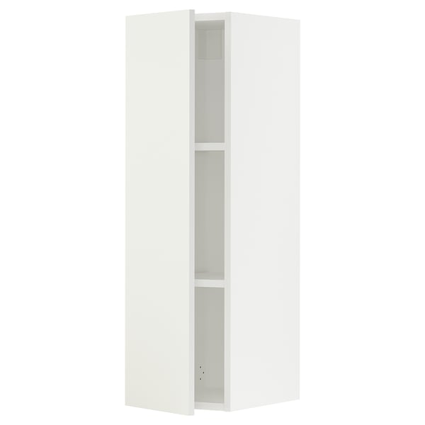 A white SEKTION kitchen cabinet with two shelves and a door slightly open, revealing the interior.