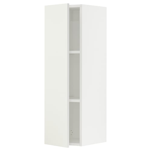 A white SEKTION kitchen cabinet with two shelves and a door slightly open, revealing the interior.