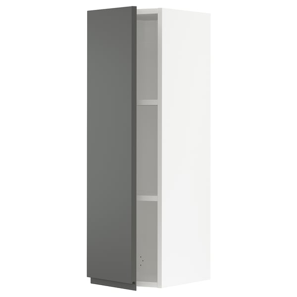 A modern grey kitchen cabinet with an adjustable shelf and slow-closing hinges.