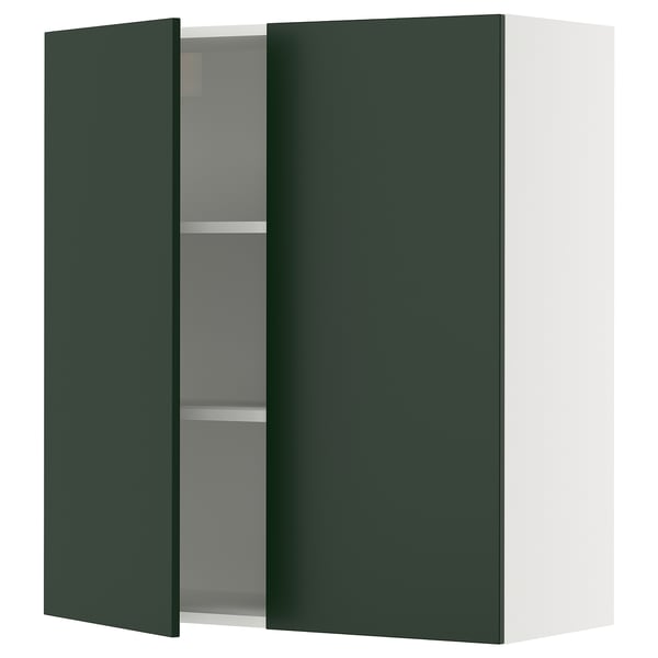 A green SEKTION kitchen cabinet with an adjustable shelf and a door that stays open gently.
