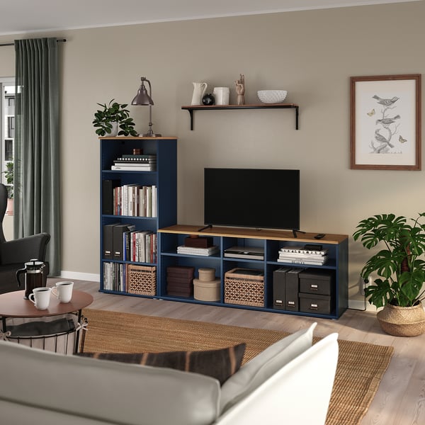 Cosy living room with SKRUVBY tv stand, plant, white sofa, and wall-mounted tv.