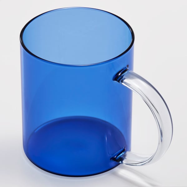 Blue opaque mug with transparent curved handle, polished edge.