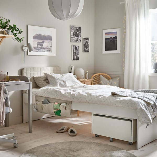 Cosy bedroom with SLÄKT bed, storage, desk, and natural light.