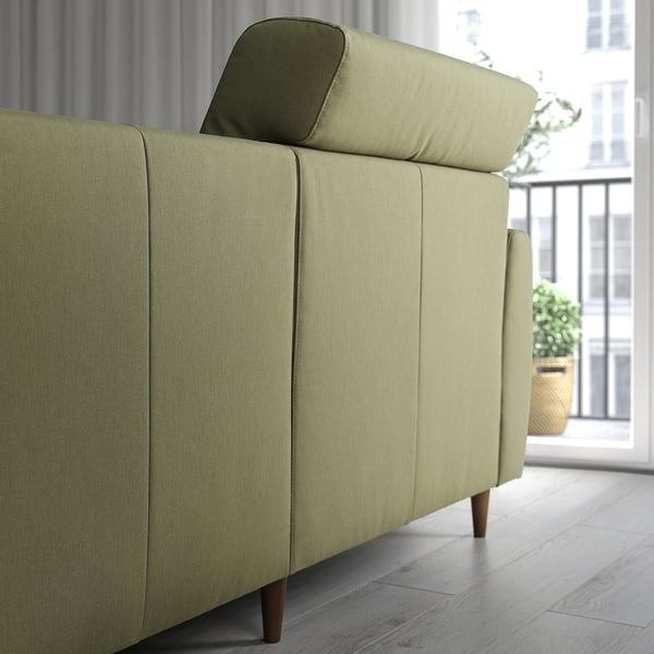 Olive-green modern sofa with a cushioned backrest, extending headrest, and a chaise longue on the right side, perfect for relaxation.