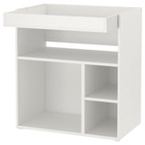 A white ikea SMÅSTAD changing table with multiple shelves, designed for a babys nursery.