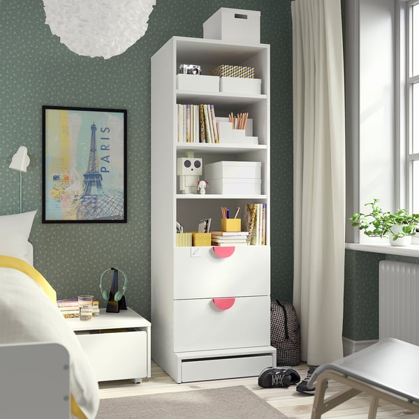 Bedroom with SMÅSTAD bookcase, yellow pillow bed, plant, eiffel tower poster, window.