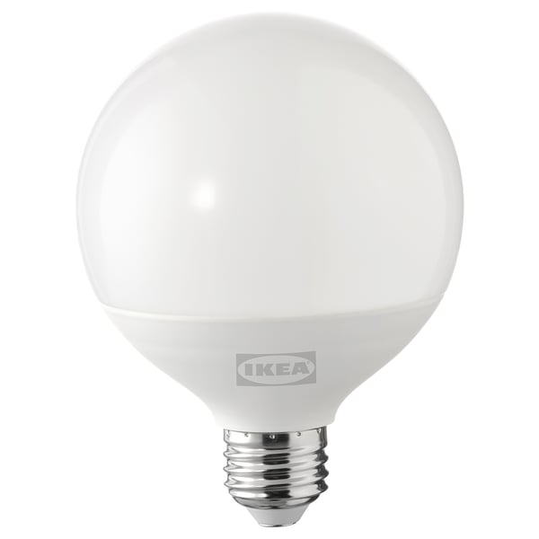 An ikea led light bulb, named SOLHETTA, round white, plastic, warm-white glow.