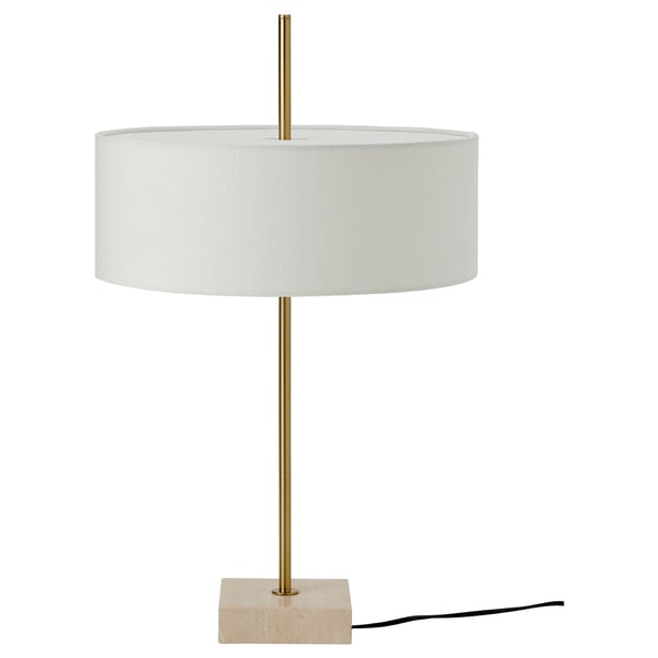 Modern lamp with brass base, travertine base, and white drum shade.