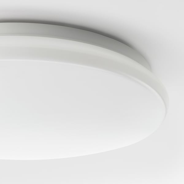 Modern round ceiling lamp with smooth white finish, emitting a bright and even glow.