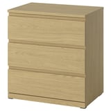 A light brown STORKLINTA chest of drawers with three drawers, smooth lines, and integrated handles.
