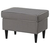 Black-and-white houndstooth patterned footstool with dark wooden legs.