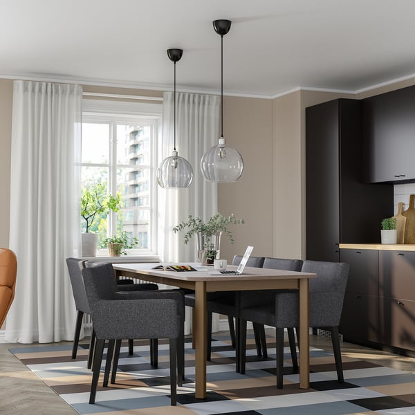 STRANDTORP 6-seat dining set, dark brown wood & steel, rectangular, modern. Large, fits well in room, with four grey cushioned chairs.