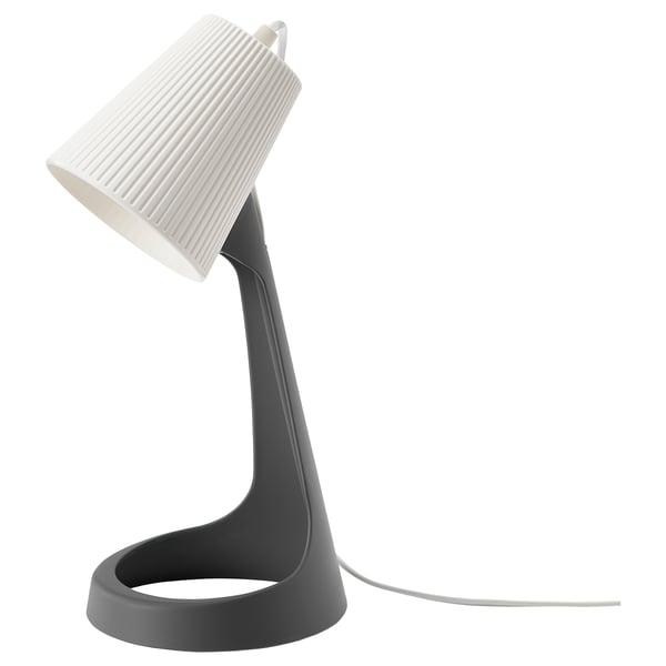 A SVALLET lamp, a modern design in black and white, made from recycled plastic, with a curved stand and a ribbed shade.