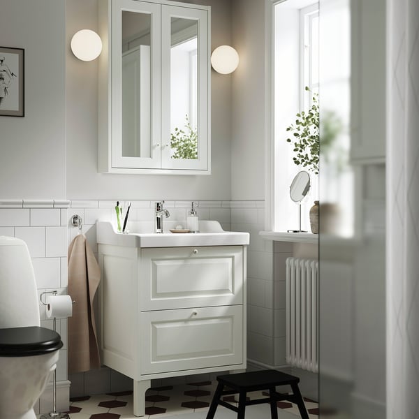 White TÄNNFORSEN mirror cabinet with bevelled panels, wall-mounted above vanity sink, large and reflective.
