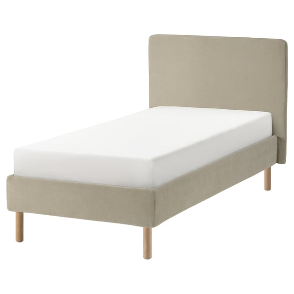 A beige upholstered bed frame, TÄRNKULLEN, with wooden legs, a padded headboard, and a white mattress.