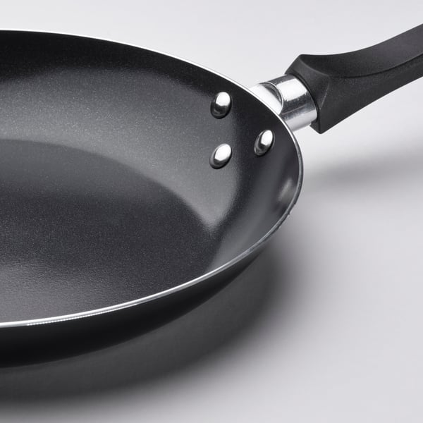 High-quality non-stick frying pan with black ceramic coating, ergonomic black handle, and stainless steel accents.