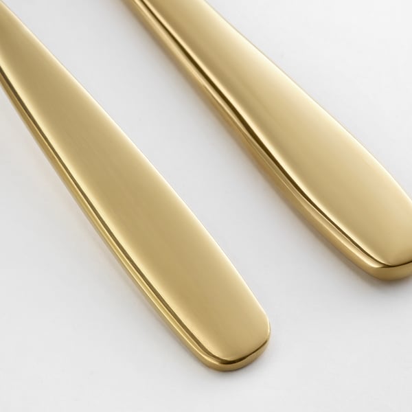 Brushed gold-colored knives; modern, sleek, high-quality metallic finish.