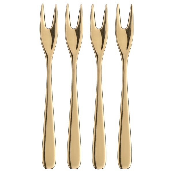 Four gold-colored, stainless steel TILLAGD cocktail forks, sleek and elegant, arranged neatly in a row.