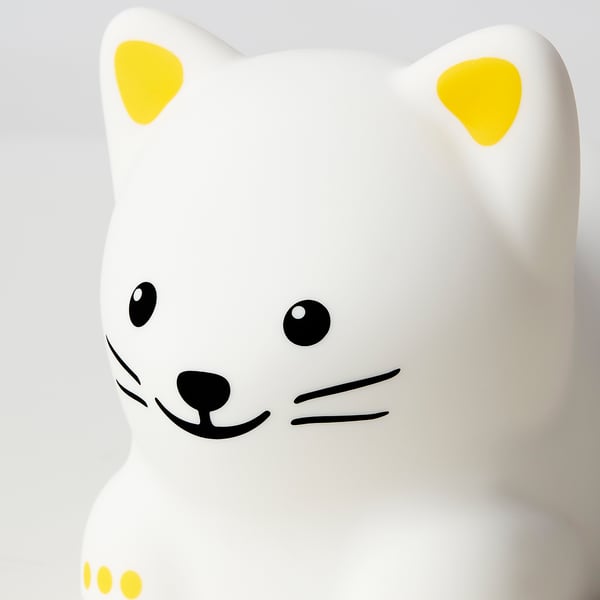 Cartoon cat night light, smooth white surface, large yellow ears, black eyes, nose, and smile. High-quality materials, safe for kids.