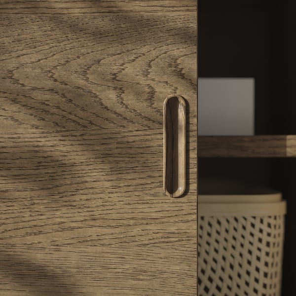 Sleek wooden cabinet with smooth sliding door and integrated handle, showcasing high-quality veneer and modern design.