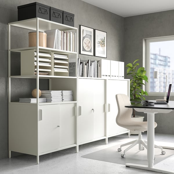 Modern home office with white TROTTEN cabinet, shelves, and desk, efficient workspace with storage.