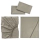 Image shows three light grey ULLVIDE bed linens: flat sheet, fitted sheet, and pillowcases, all neatly folded or displayed.