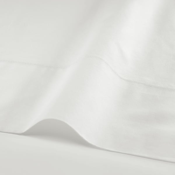 Crisp, white bedding with a smooth, tightly woven texture, showcasing high-quality fabric.