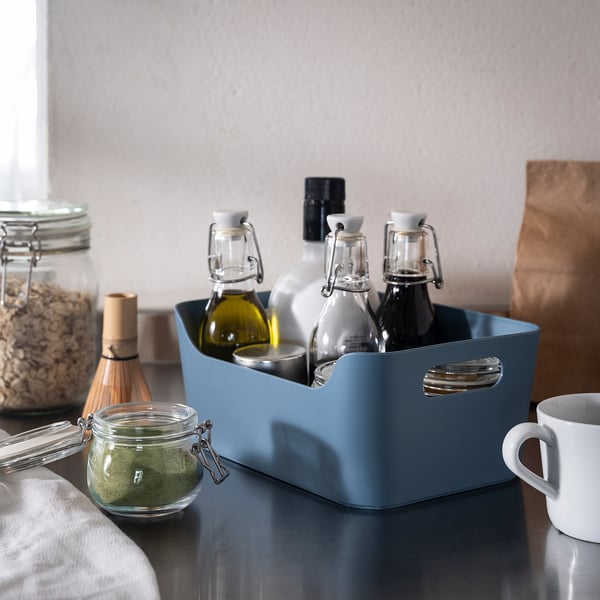 Blue UPPDATERA plastic box holding bottles, jar on table, small, organiser.