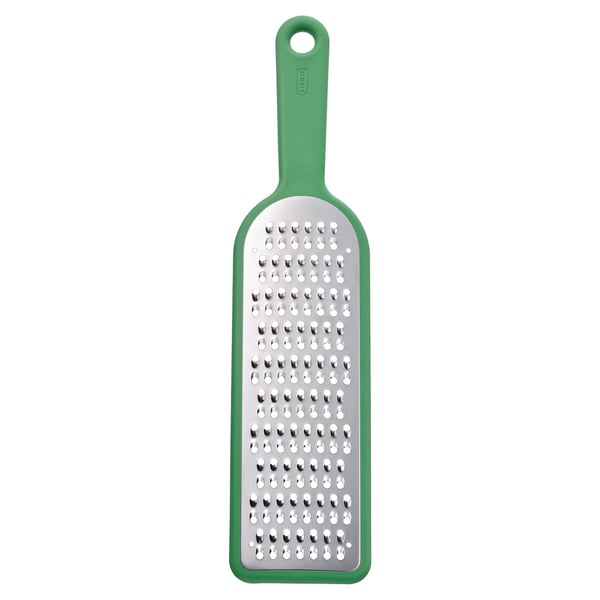 Green kitchen grater with stainless steel surface and green plastic handle for gripping and storing.