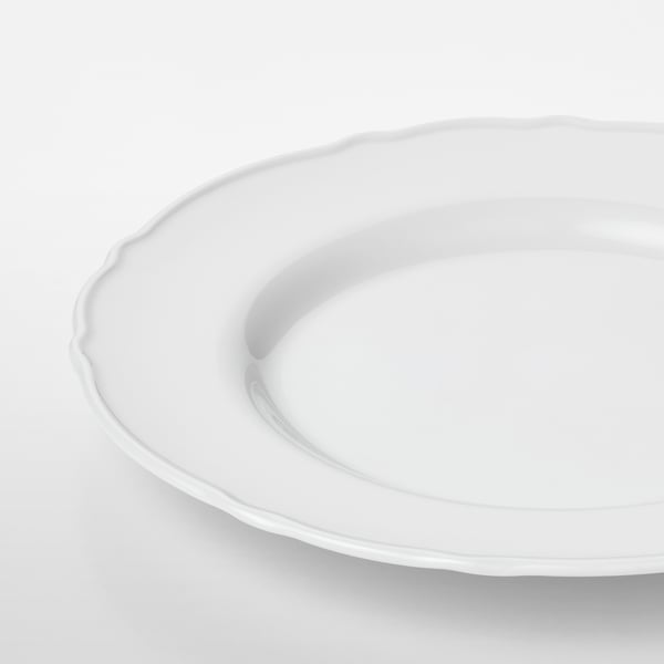 Crisp white porcelain plate with delicate, ruffled edge. Smooth, durable, and elegant.