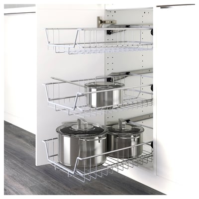 Kitchen cabinet with wire baskets holding stacked pots and pans, showing organised storage and easy access.
