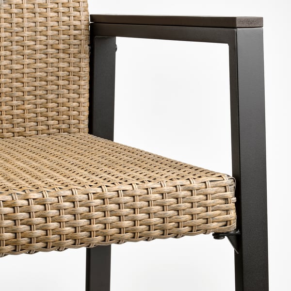 A modern patio chair with a black metal frame and intricate woven seat and backrest. The craftsmanship is evident, promising durability and comfort.