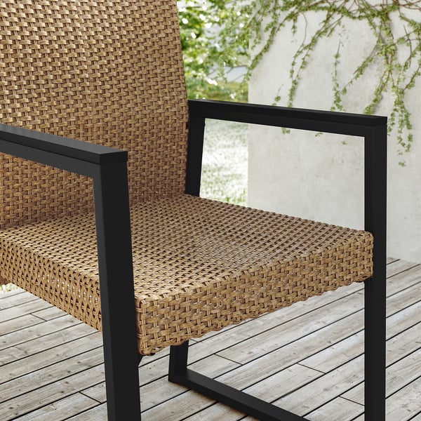 Modern outdoor chair, VÄRMANSÖ: black metal, woven natural rattan seat & back, weather-resistant, comfy shape.