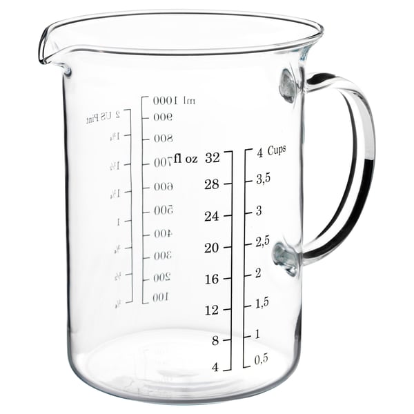 Clear glass measuring jug, black handle, with cup and ounce markings, suitable for baking, microwave and dishwasher safe.