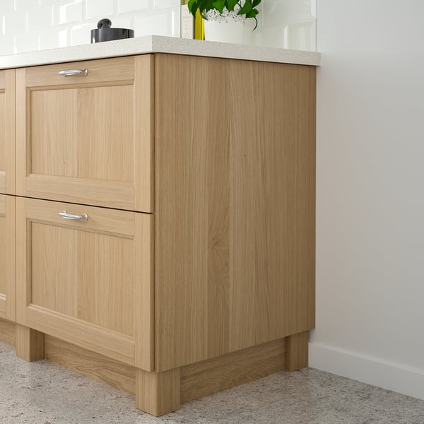 VEDHAMN light oak cabinet with drawers, silver handles, and floral vase.